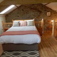 Spacious bedroom with king-sized bed in The Hayloft